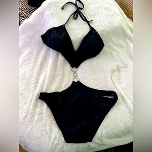 Black “cut-out” bathing suit with silver rings over the belly for a sexy look.
